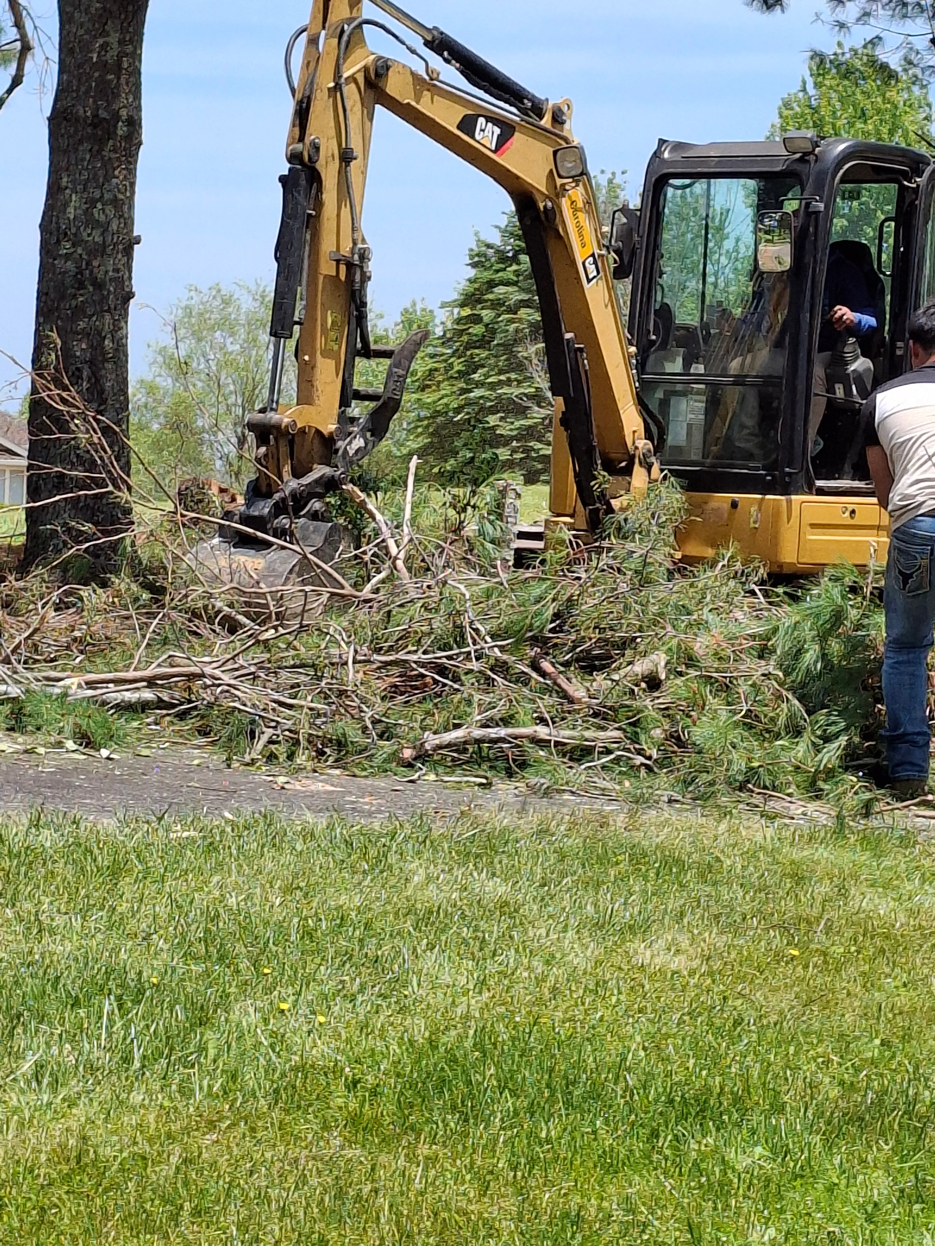 A tracked excavator clearing a wooded lot on a High Country property in Watauga County, NC